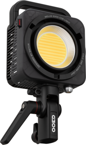 800q-01_127297 Zhiyun LED Molus G300 COB luminaire in black with a yellow central LED mounted on an adjustable black base with side openings and top handle visible.