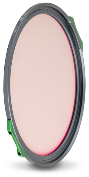 800q-01_129304 The NiSi JetMag Pro UV/IR Cut filter is a round, pale pink-tinted lens filter with a thin, dark grey metal frame and two green tabs on opposite sides, and is shown here standing upright against a white background.