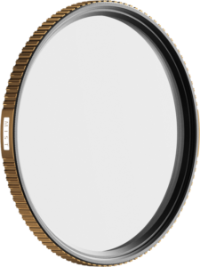 PolarPro Quartzline Mist (1/4 diffuusio) -suodattimessa 67 mm on kultainen harjattu reuna, pieni "MIST"-merkintä ja läpinäkyvä lasi ohuessa metallirenkaassa. Tausta on vaalea ja tavallinen.