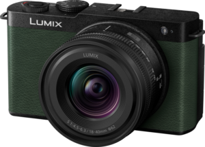 The Panasonic Lumix S9 Dark Olive 18-40mm f/4.5-6.3 lens with textured grip and adjustment dials is visible from the front against a light background.