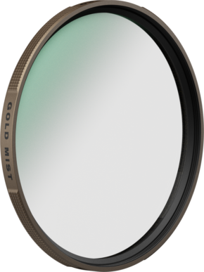 800q-01_131067 The PolarPro 135 series gold mist filter 77mm diffusion filter has a gold-coloured metal edge and a subtle green tinted glass that appears on a plain white background.