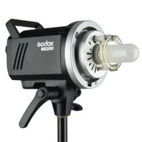 ms300 Lähikuva Godox MS300 + jalusta (sis. ALV 25,5%) - Käytetty mustasta studiostrobovalaisimesta, joka on asennettu jalustalle ja jossa korostuu sen lamppu ja hopeinen etuheijastinkotelo.