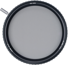 800q-01_117836 The NiSi TRUE COLOR ND-VARIO 1-5 Stop 86mm adjustable grey filter is a round lens filter with a textured edge and a small adjustment lever, viewed from above against a light background.