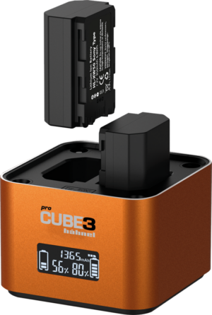 800q-01_130451 A close-up of the orange Hähnel ProCube 3 Twin Charger Sony charger shows one battery inserted in place, the other inserted above and its illuminated digital display showing charging information.