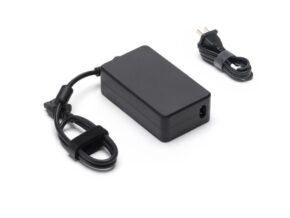 1103176-DJI-Mavic-240W-power-adapter_2 The DJI 240W Power Supply EU Power Supply is a black rectangular power supply with an attached cord and a separate power plug cord, both attached with Velcro strips, shown on a white background.