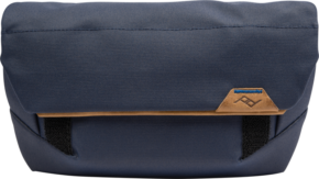 800q-01_123330 Peak Design The Field Pouch v2 // Midnight is a rectangular navy blue pouch with tan leather accents, black straps and a small stitched logo on the front.
