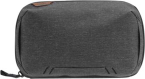 800q-01_123338 The Peak Design Tech Pouch in Charcoal is a rectangular travel pouch with a zip closure, a small leather accent on the top left corner and subtle stitching on the front.