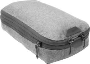 800q-01_123361 Peak Design Packing Cube // Small // Charcoal is a grey rectangular fabric organizer with two zippers and a small logo flap, designed for efficient organization of luggage.
