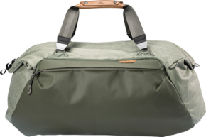 800q-02_123350 The Peak Design Travel 65L Duffel Sage features a roomy zippered front pocket, sturdy grey handles with brown leather accents, and is patterned against a light background.