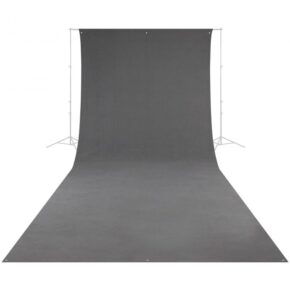 The Westcott Wrinkle-Resistant Backdrop - Grey (270 x 610 cm) is vertically stretched and extends to the floor, supported by a metal frame with tripods on either side.