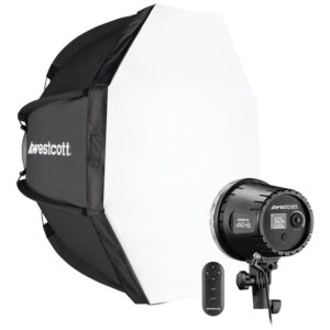 The Westcott U60-B Bi-Color LED 1-Light Softbox Kit (60W) is a studio lighting kit with a large octagonal softbox, a studio light with rear controls and a small wireless remote control, all with the Westcott logo.