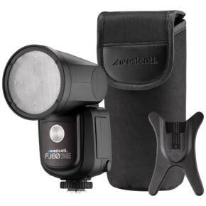 1707403312_288 The Westcott FJ80-SE M Universal 80Ws Speedlight (Canon, Nikon, Fuji, Panasonic, Olympus) is presented next to a black protective case and a small black stand on a white background.