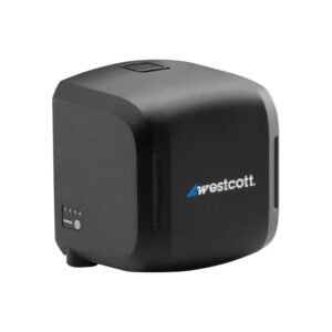 1742481693_254 The Westcott FJ ProMax AC/DC battery and power adapter for FJ800 and FJ400 II flashlights is a black, cube-shaped device with LED panel and side button, with a white and blue Westcott logo on the front.