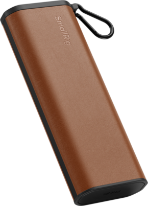 Rectangular, brown and black SmallRig 4532 Multifunctional Card Reader & Storage Case CFexpress Type B case with leather-like texture and black carabiner clip on the top corner.