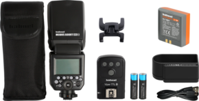 800q-01_111512 The Hähnel Modus 600RT MK II Wireless Kit Nikon flash kit includes a flash unit, carrying case, flash stand, wireless shutter release, two AA batteries, camera battery, charger and cable, arranged on a white background.