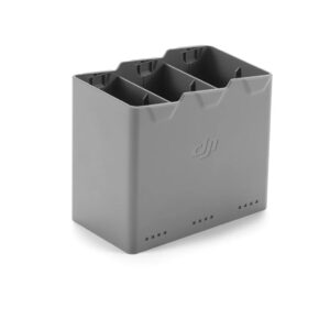 charging hub The DJI Mini 5 Pro Two-Way Charging Hub is a grey, rectangular charging hub with three slots for charging multiple drone batteries and a DJI logo on the side.