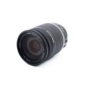 Canon Zoom-objektiivi EF-S 18-55mm f/3.5-5.6 on sijoitettu valkoiselle taustalle, hieman vasemmalle kallistettuna, jolloin etulasi ja zoom-merkinnät näkyvät.