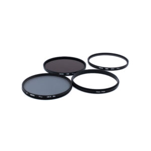 Hoya Digital Filter kit 77mm Neljä pyöreää mustilla reunoilla varustettua kameran linssisuodatinta, joissa on merkinnät "HOYA" ja "77mm", on sijoitettu valkoiselle pinnalle. Suodattimissa on vaihtelevia harmaan ja kirkkaan lasin sävyjä.