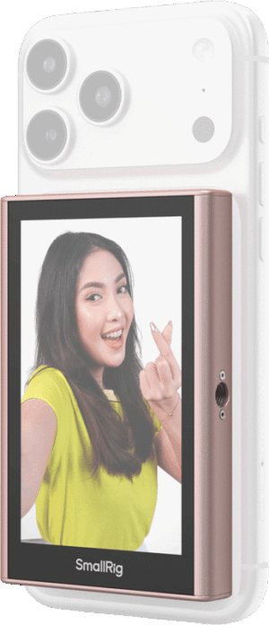 800q-01_135150 A woman in a yellow shirt smiles and makes a heart-shaped gesture with her finger as the camera lenses of her smartphone, equipped with the SmallRig 5746 Wireless Display Mirroring Adapter for Mobile Phone - Selfie Kit, are shown up.
