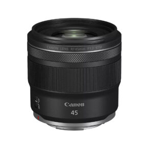 The black Canon RF 45mm f/1.2 STM lens stands upright against a white background, with its textured rings and side switch.